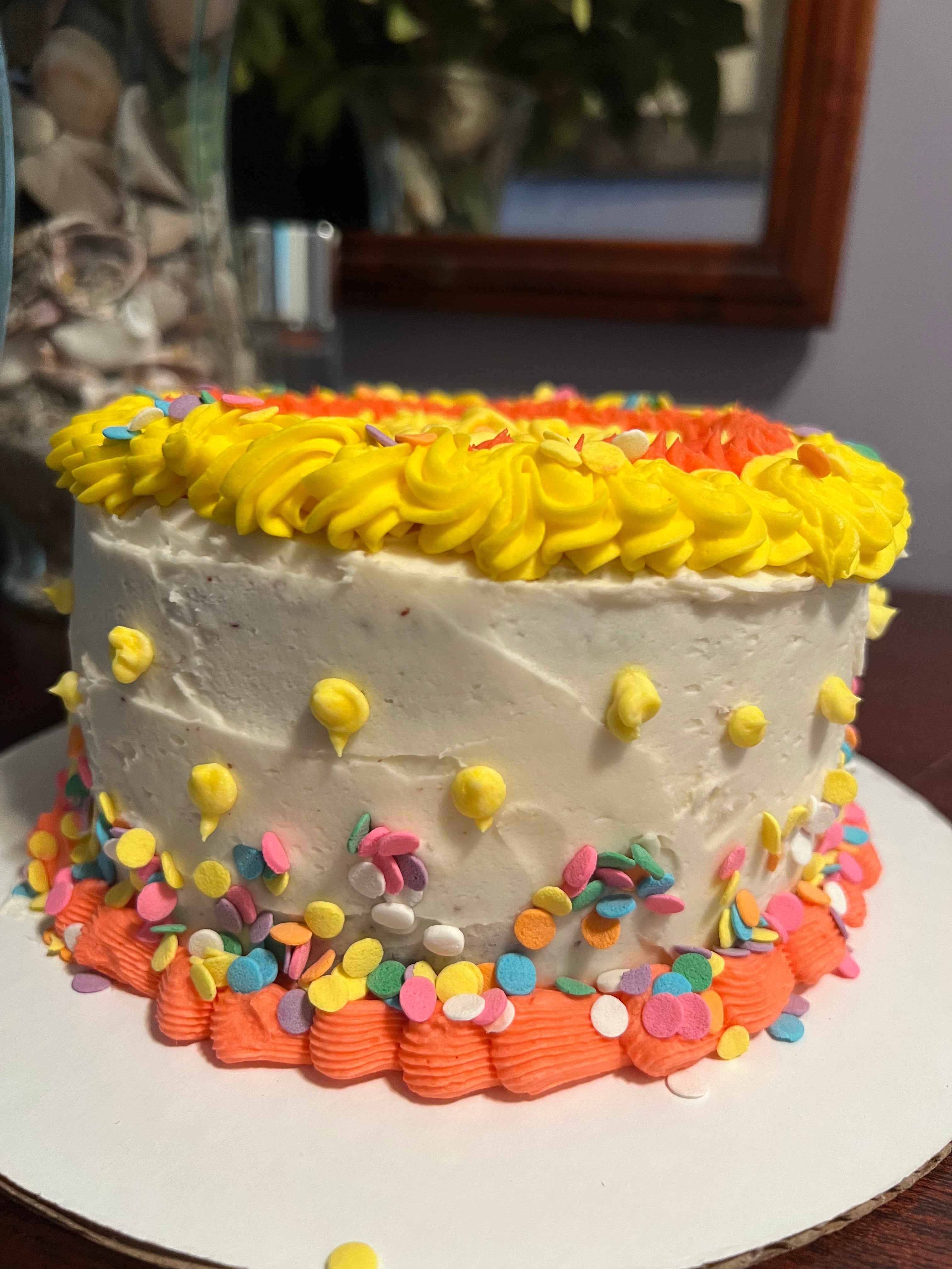 Round 8 in cake with frosting and sprinkles